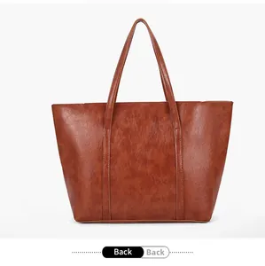 Back view of a large brown vintage faux leather tote bag with double handle design