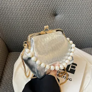 Silver pleated shell bag with pearl handle and chain strap for vintage styling