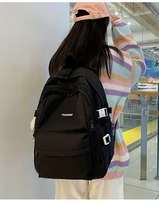 Student backpack with adjustable white buckles and fashion label in daily usage