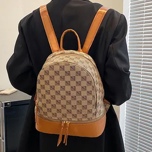 Women's chic PU leather backpack with vintage check pattern on a female model