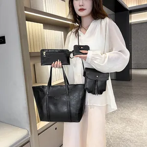 Black 4-piece tote bag set with crossbody bag and clutch shown in lifestyle setting