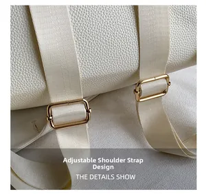 Close-up of adjustable woven shoulder strap with gold metal buckle on white leather backpack