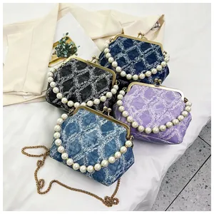 Detailed close-up of shell bags with pearl handles and metallic kiss-lock clasps