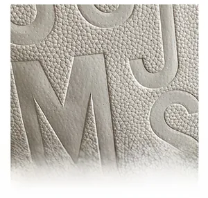 Macro shot of waterproof pebble grain leather texture with embossed capital letters