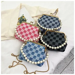Close-up of checkered woven handbags with pearl handles and vintage metal clasps in four colors