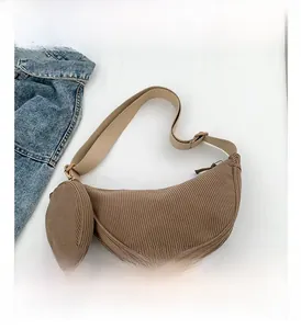 Detail view of brown corduroy crescent bag with matching small round coin purse attachment