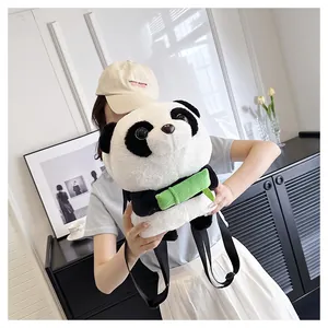 Close-up of a plush panda backpack showing soft fabric and green bamboo detail on a model