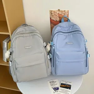 Minimalist high-capacity nylon school backpacks in grey and blue with teddy bear charm
