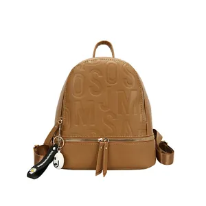 Waterproof brown leather backpack with embossed letters and daisy charm accessory