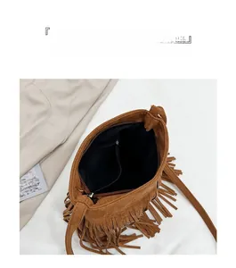 Vue intérieure du sac seau en daim marron avec doublure à poches et détails de franges
