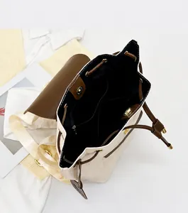 Interior view of checkered bucket backpack showing spacious storage and fabric lining