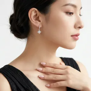 Elegant S925 silver star moon earrings with sparkling moissanite on female model