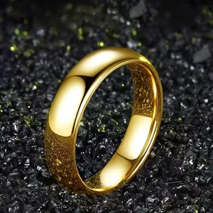 Close-up of polished gold band ring resting on black glossy stones for a luxurious look