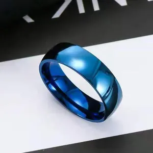 Close-up of minimalist sapphire blue stainless steel ring with polished mirror finish