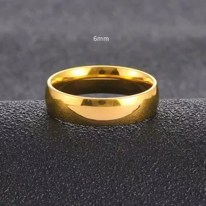 Macro detail of a 6mm gold minimalist stainless steel ring with polished mirror finish