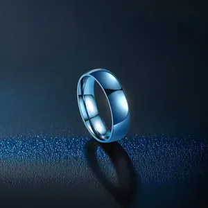 Macro shot of minimalist polished blue stainless steel ring on a textured dark background