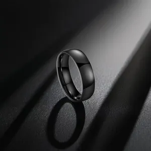 Polished black stainless steel ring detail with mirror finish and elegant lighting shadows