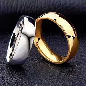 Macro shot of polished gold and silver stainless steel couple rings on dark leather background