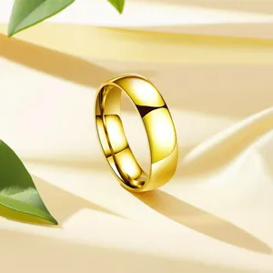 Macro view of a polished golden stainless steel band ring on soft satin fabric