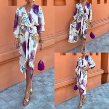 Detail of elegant French floral print maxi dress with V-neckline and waist tie design