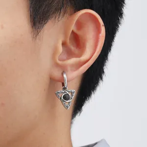 Detail of men's Celtic knot hoop earring with black opal stone on a male model