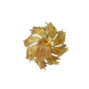 Vintage gold-plated twisted starburst brooch with intricate sunburst texture for women