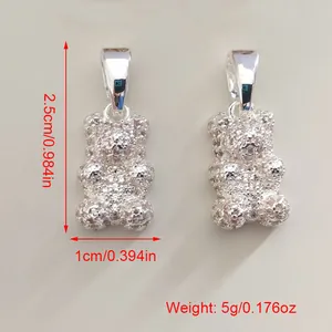 Detailed macro view of textured silver bear pendant including size and weight specs