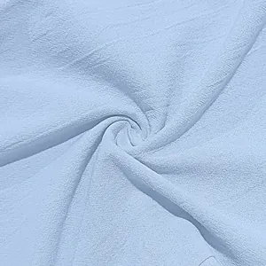 Macro texture of light blue cotton linen fabric showing breathable weave detail