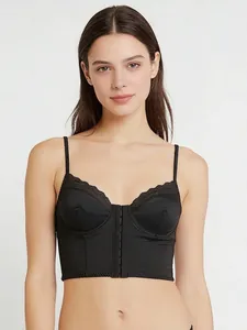 Macro shot of black satin corset bra with delicate lace trim and front hook closure