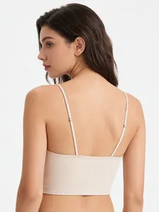 Close-up of adjustable straps and flat back seam on beige satin corset top for women