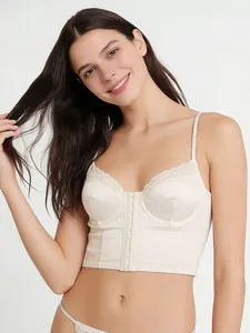 Detailed view of ivory satin corset bra with delicate lace trim and front hook closure