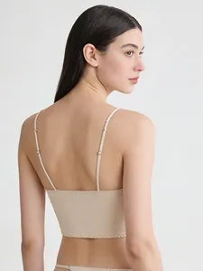 Detailed view of adjustable metal buckles and zigzag stitching on a satin bustier top