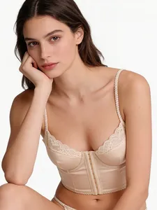 Detailed view of beige satin corset bra featuring lace trim and front hook-and-eye closure