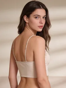 Detailed back view of sleek beige satin corset top with delicate lace trim and thin straps