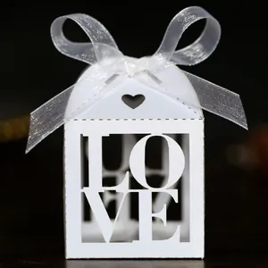 Close-up of white hollowed-out LOVE candy box with heart details and elegant satin ribbon