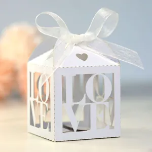 Detail of ivory laser-cut gift box with LOVE hollow design and white organza ribbon bow