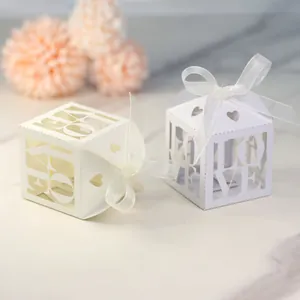 Detail of hollow LOVE cutout and heart design on ivory wedding favor gift boxes