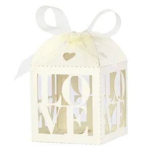 Ivory white laser-cut 'LOVE' wedding favor box with heart detail and white ribbon bow