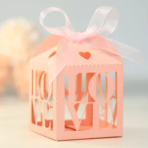 Detailed view of pink laser-cut LOVE gift box with decorative heart and silk ribbon