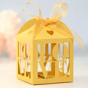 Detail of laser-cut heart candy box with LOVE lettering and yellow organza ribbon