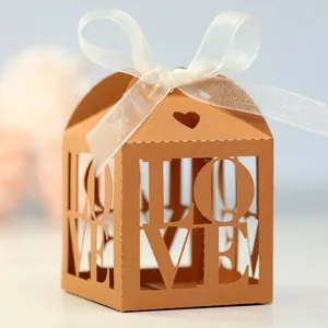 Detailed laser-cut LOVE lettering on orange cardstock wedding candy favor box with ribbon
