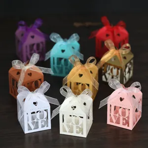 Detailed laser-cut candy gift boxes featuring LOVE cutout design and organza ribbons