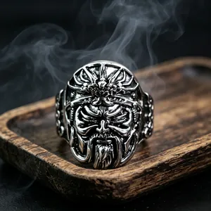 Men's vintage silver ring featuring a detailed warrior face relief on a dark background