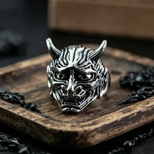 Detailed view of a vintage silver Hannya mask ring with intricate gothic metal carving