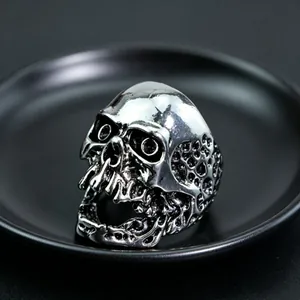 Macro shot of a skull-shaped metal ring with realistic details and dark punk aesthetic