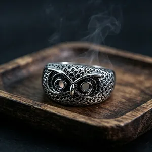 Detailed macro view of vintage owl ring with intricate silver-toned feathers and eyes