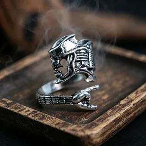 Macro shot of vintage silver skull ring with rock gesture design on dark wood