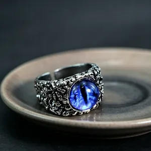Detailed macro view of gothic dragon eye ring with textured silver metal and blue iris
