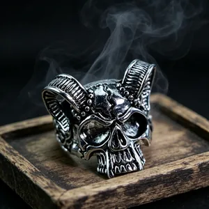 Macro shot of gothic skull and horn ring with vintage oxidized finish and smoke detail