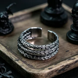 Close-up of vintage oxidized metal cuff bracelet with triple-layer curb chain weaving